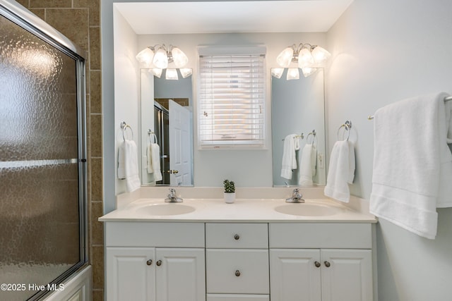 bathroom featuring vanity and bath / shower combo with glass door