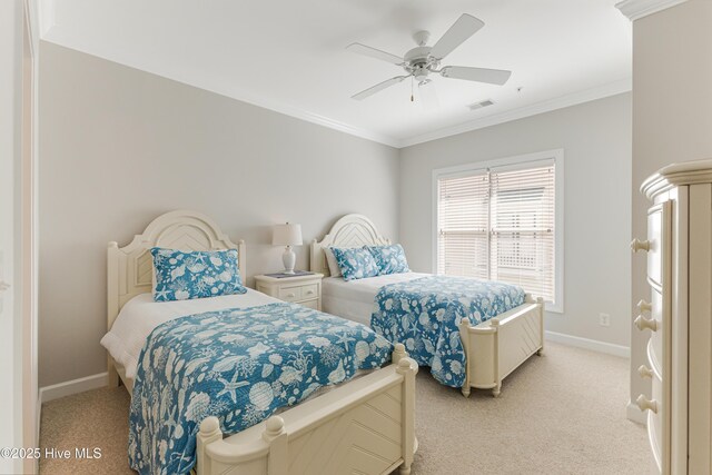 carpeted bedroom with ornamental molding and ceiling fan