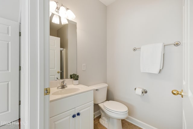 bathroom featuring vanity, tile patterned floors, and toilet