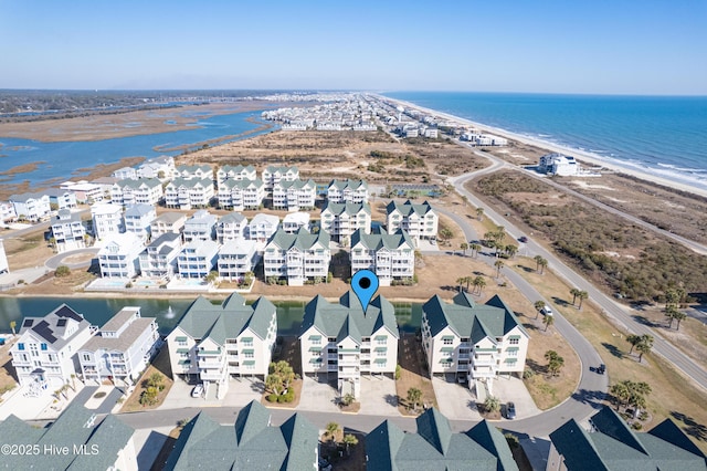 bird's eye view featuring a water view and a view of the beach