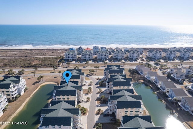 bird's eye view with a water view and a beach view