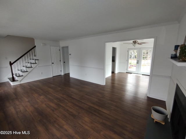 unfurnished living room featuring ornamental molding, dark hardwood / wood-style floors, ceiling fan, and french doors