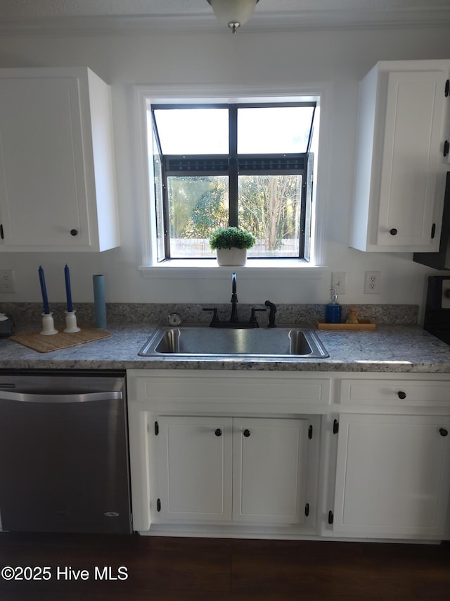 kitchen featuring dishwasher, sink, and white cabinets