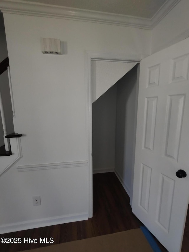 hall with crown molding and dark hardwood / wood-style flooring