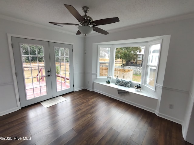 interior space with french doors, dark hardwood / wood-style flooring, a textured ceiling, and a wealth of natural light