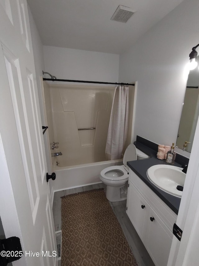 full bathroom featuring vanity, shower / bath combination with curtain, and toilet