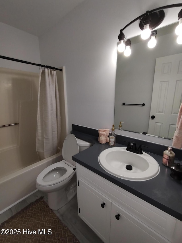 full bathroom featuring shower / bath combination with curtain, vanity, and toilet