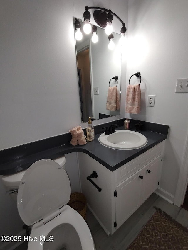 bathroom featuring vanity and toilet