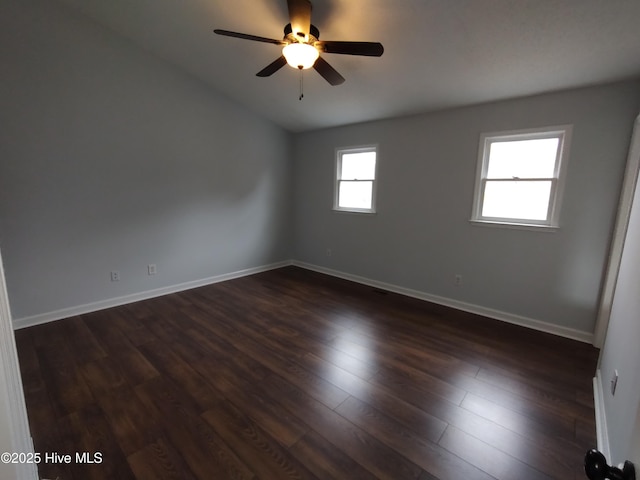 empty room featuring dark hardwood / wood-style flooring and ceiling fan