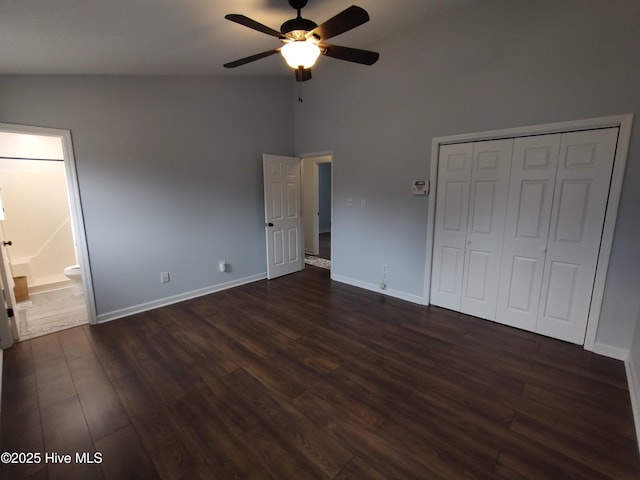 unfurnished bedroom with ensuite bath, vaulted ceiling, dark hardwood / wood-style flooring, a closet, and ceiling fan