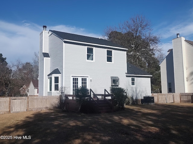 rear view of property featuring a deck and central air condition unit