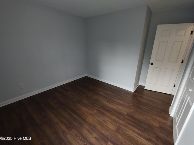 unfurnished room with dark hardwood / wood-style floors