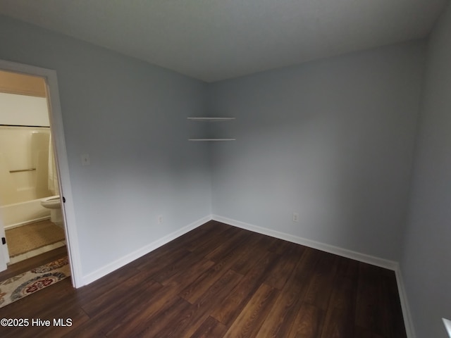 unfurnished room featuring dark wood-type flooring