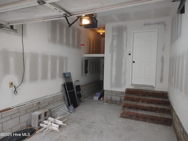 garage with a garage door opener and electric panel