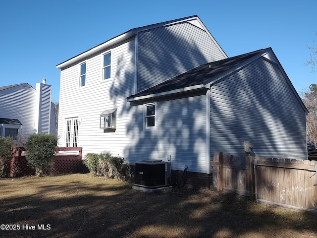 back of house with central AC unit