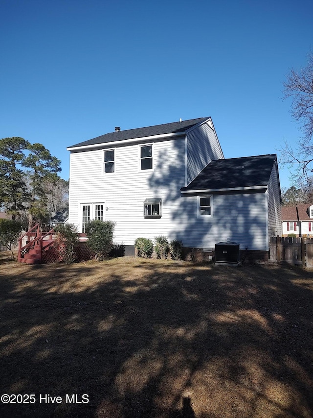 back of house with cooling unit and a wooden deck