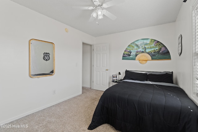 bedroom featuring light carpet and ceiling fan