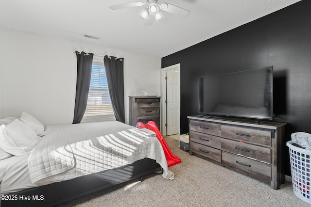 bedroom with light carpet, a textured ceiling, and ceiling fan