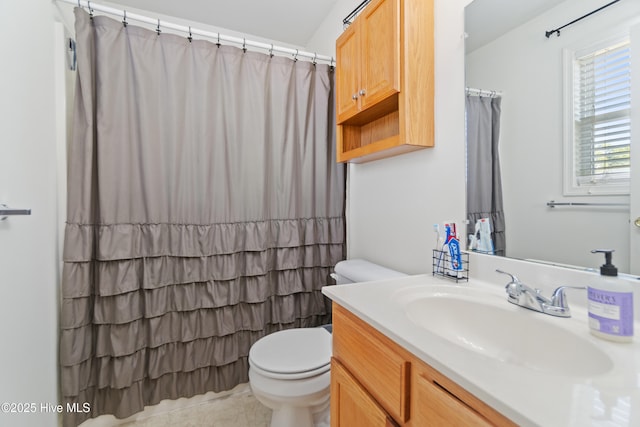 bathroom with tile patterned floors, vanity, and toilet