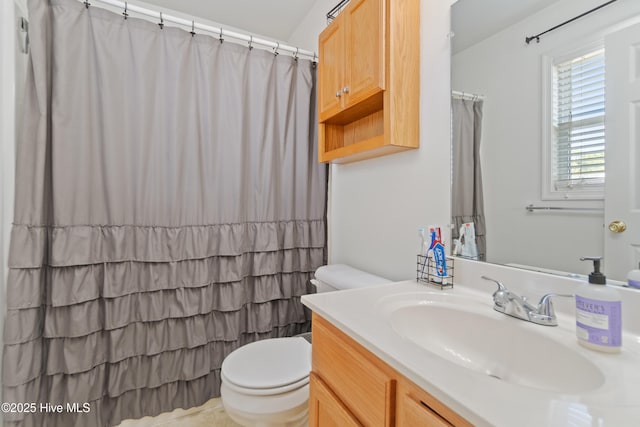 bathroom featuring vanity, toilet, and walk in shower