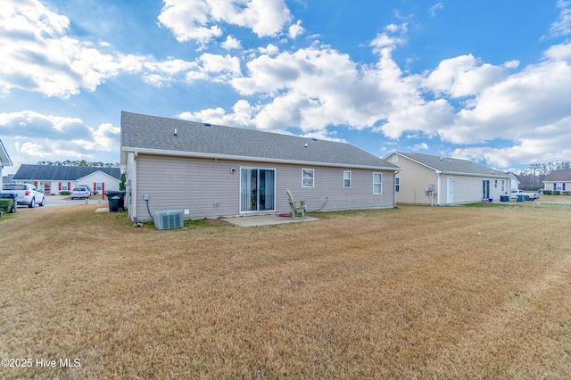 back of house with a lawn, cooling unit, and a patio area