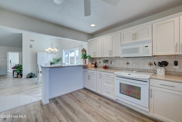 kitchen featuring light wood-type flooring, white cabinets, white appliances, and decorative backsplash