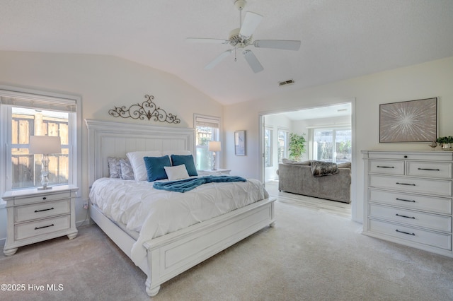 bedroom with ceiling fan, light colored carpet, and lofted ceiling