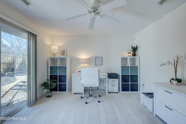 carpeted office space featuring a textured ceiling