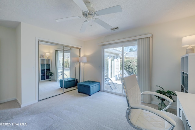 office with ceiling fan, light colored carpet, and a textured ceiling