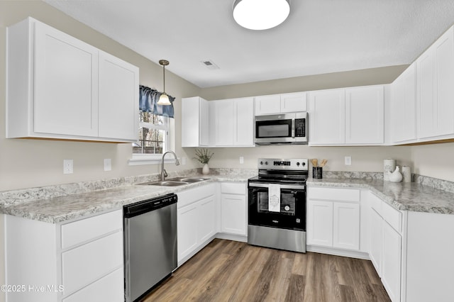 kitchen with white cabinetry, appliances with stainless steel finishes, and sink