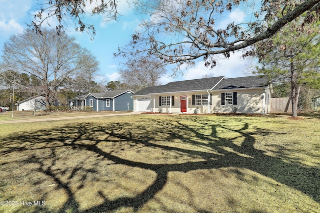 ranch-style home featuring a garage and a front lawn