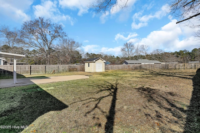 view of yard with a storage shed and a patio area