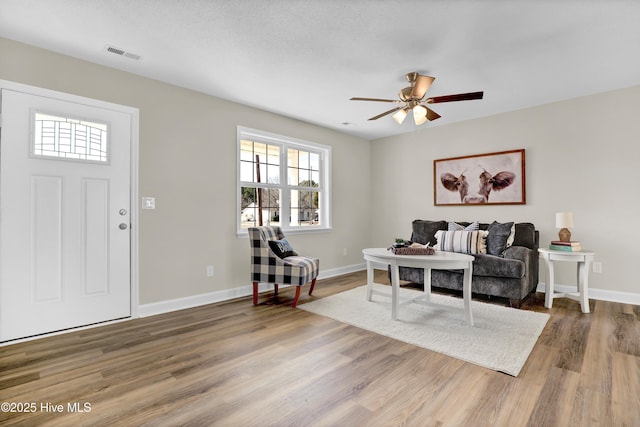 living room with hardwood / wood-style floors and ceiling fan