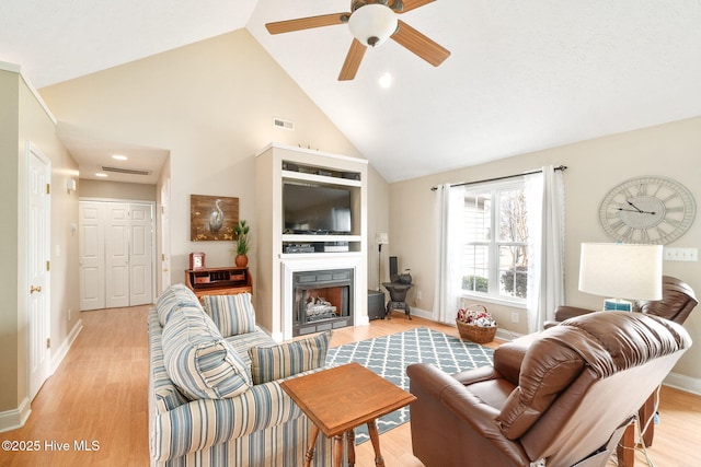 living room featuring ceiling fan, high vaulted ceiling, and light hardwood / wood-style floors