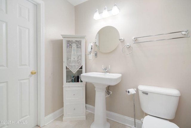 bathroom with tile patterned flooring and toilet