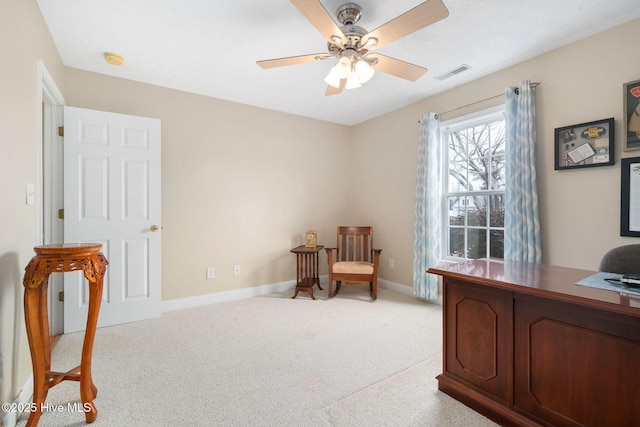 carpeted office space featuring ceiling fan