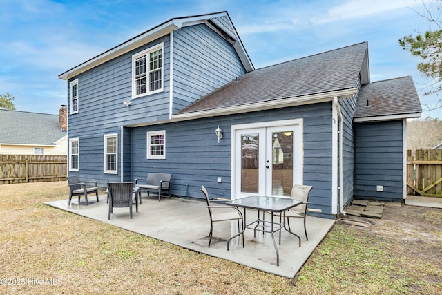 back of property featuring a yard, a patio area, and french doors