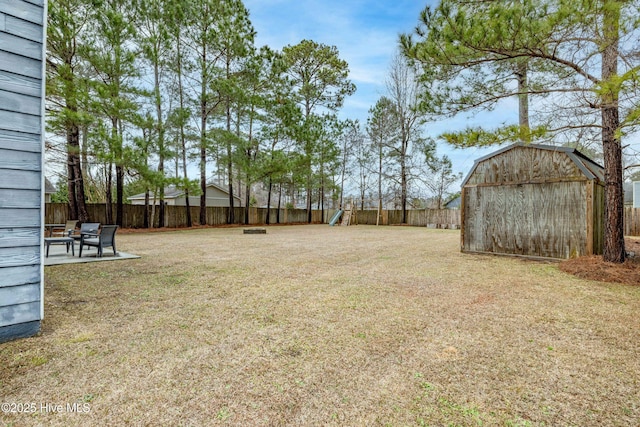 view of yard with a storage shed and a patio area