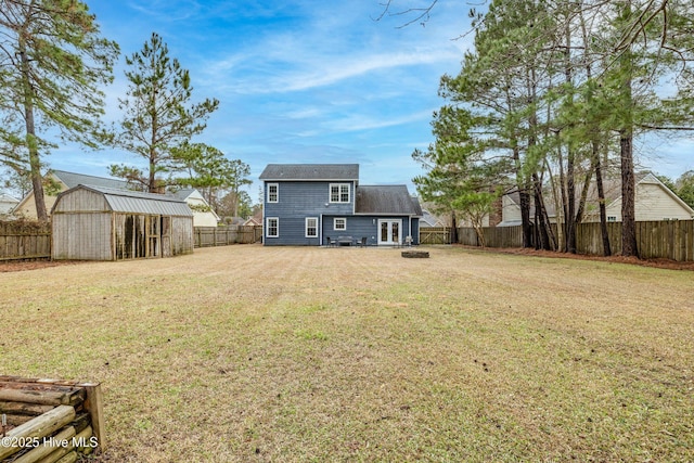 back of property with a lawn and a storage unit