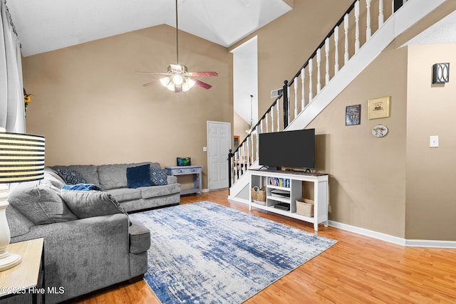 living room featuring wood-type flooring, high vaulted ceiling, and ceiling fan