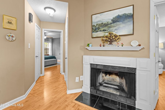 hallway featuring a textured ceiling and light hardwood / wood-style floors