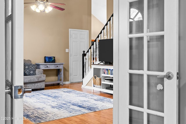 foyer featuring ceiling fan and wood-type flooring