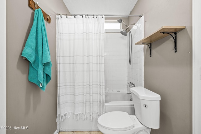 bathroom featuring shower / bath combo and toilet