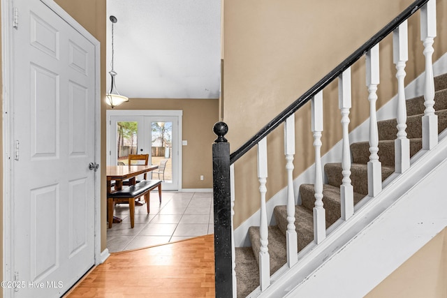 entryway featuring wood-type flooring and french doors