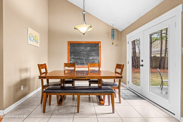 dining room with vaulted ceiling, plenty of natural light, light tile patterned flooring, and french doors