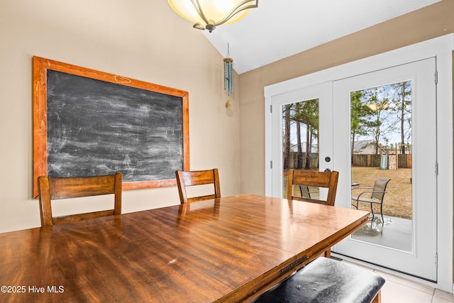 dining space with french doors and vaulted ceiling