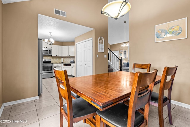 dining space with an inviting chandelier and light tile patterned floors