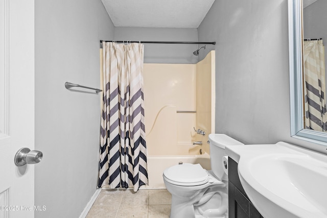 full bathroom featuring toilet, sink, a textured ceiling, shower / bath combo, and tile patterned flooring