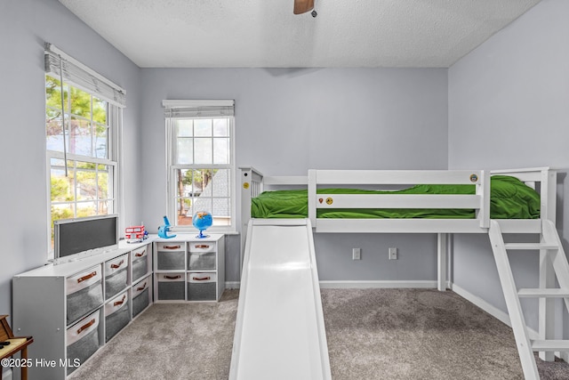 bedroom featuring carpet floors and a textured ceiling