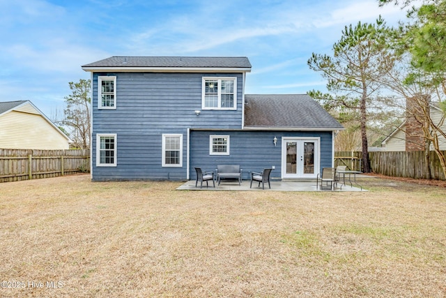 rear view of house with a patio, outdoor lounge area, a lawn, and french doors